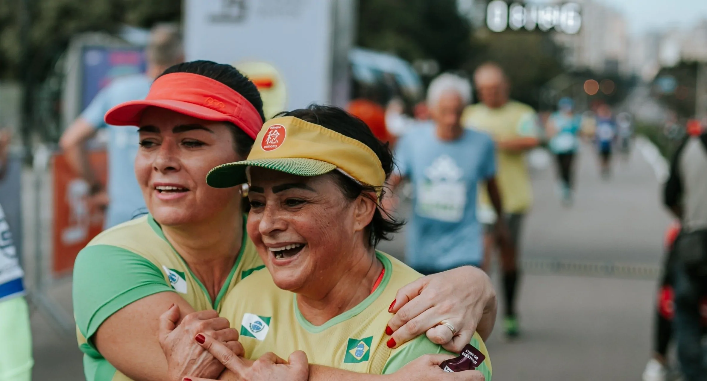 Two runners celebrating together at the end of a race